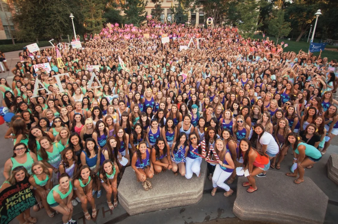 A large chapter of sorority members gathered together outdoors